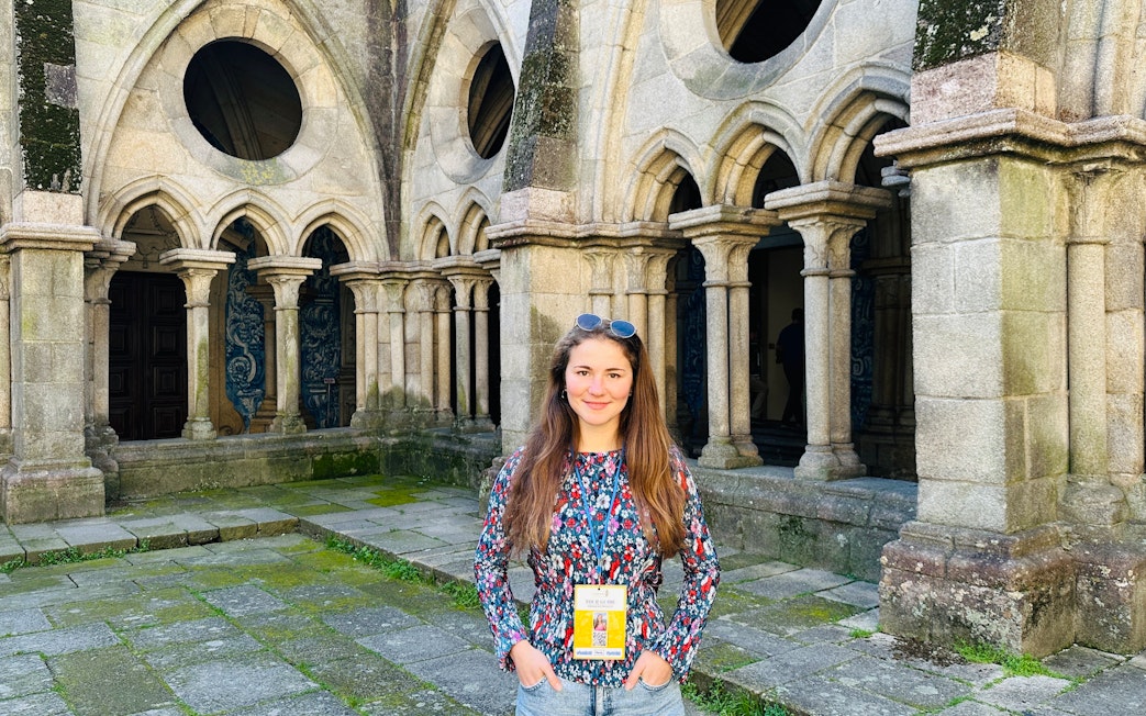 Guide standing inside the Porto Cathedral near stone arches.