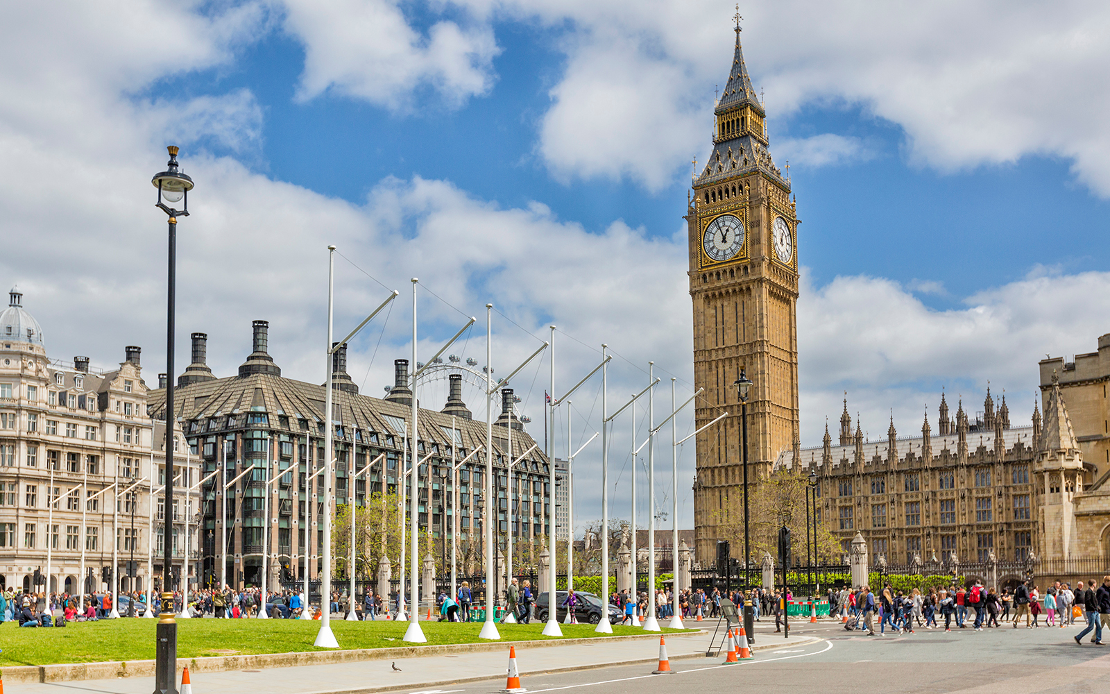 Big Ben and Westminster Palace in London with tourists nearby.