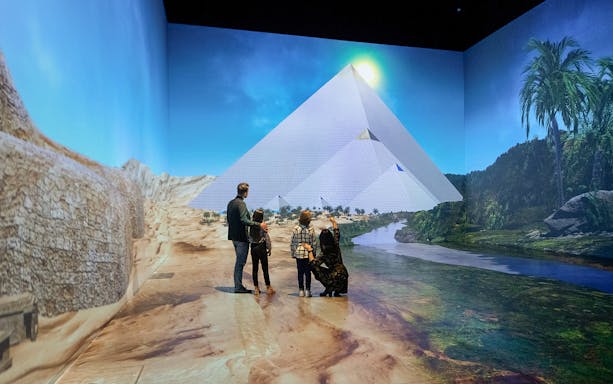Visitors exploring a digital pyramid at Tutanchamun immersive exhibition.
