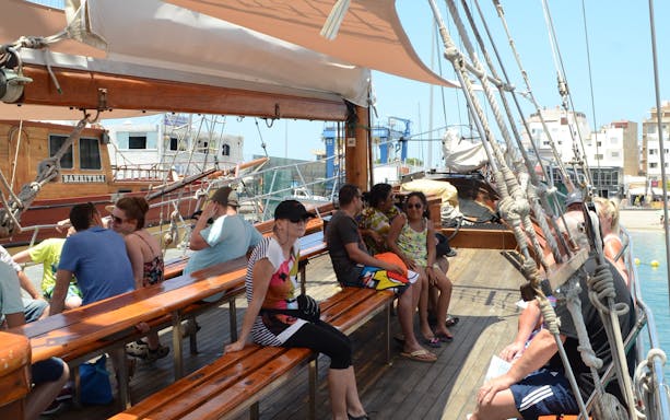 Tourists seated on Peter Pan Pirate boat in Tenerife, preparing for whale and dolphin watching.