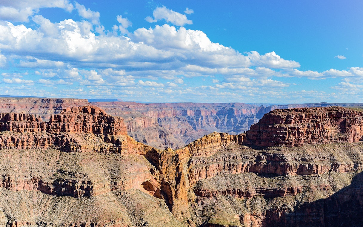 Grand Canyon Eagle Point with layered rock formations under a blue sky.