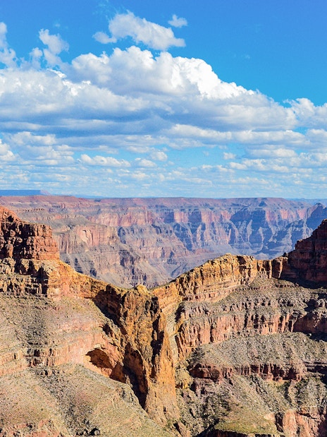 Grand Canyon Eagle Point with layered rock formations under a blue sky.