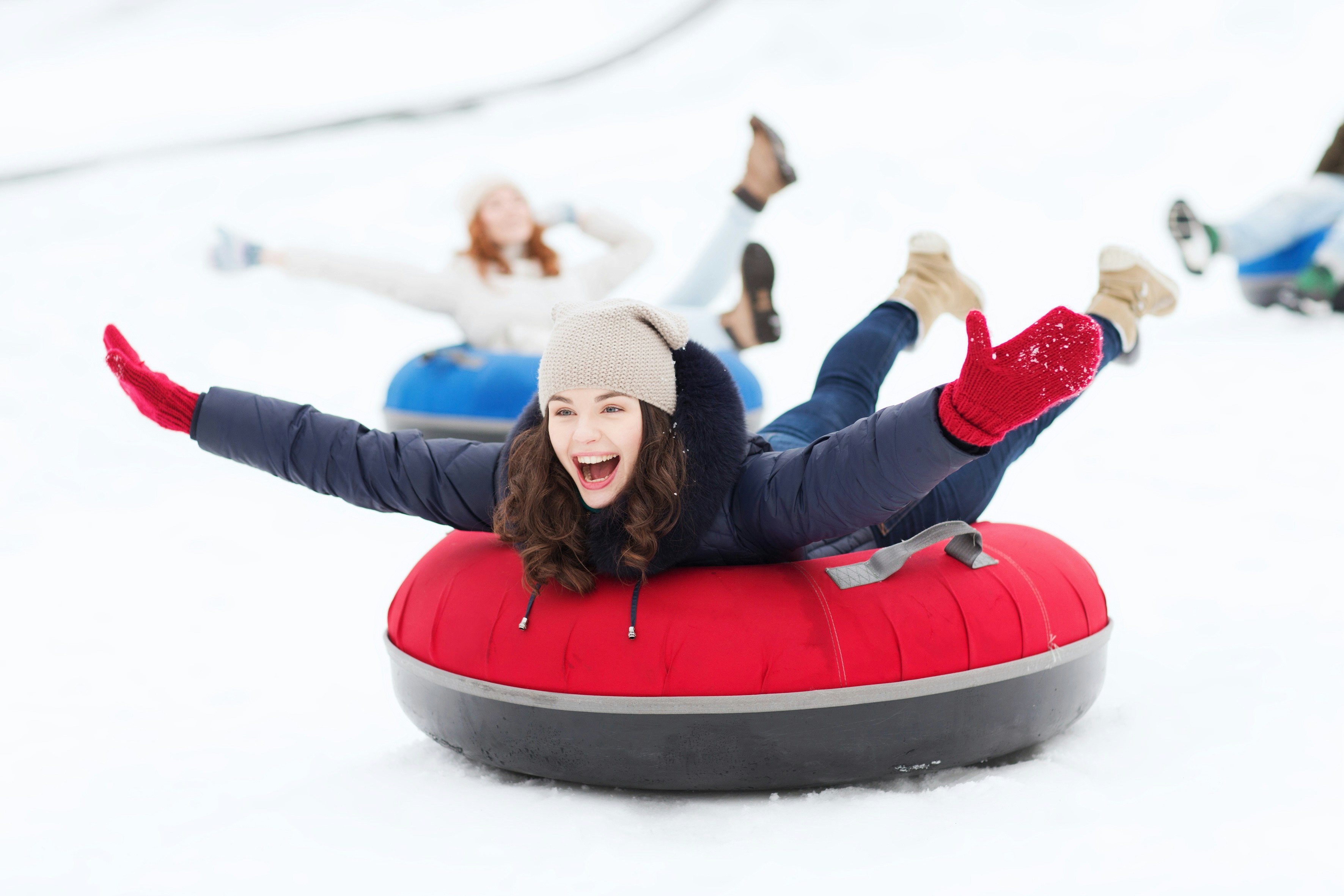 Snow tubing experience at Antalya Aquarium with people enjoying the snowy slopes.