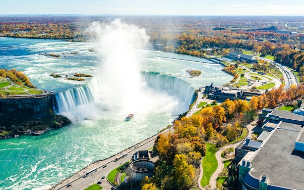 Niagara Falls with tour boat approaching Horseshoe Falls, Canada.