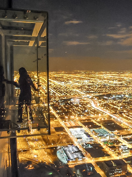 View of Chicago city lights from Willis Tower Skydeck at night.