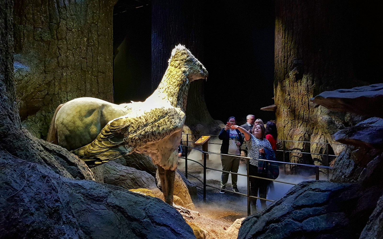 Visitors at Harry Potter Studios with Buckbeak model, London film location tour.