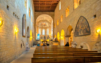 Visitors seated inside the historic chapel at Prague Castle.
