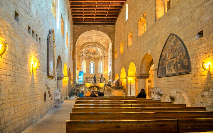 Visitors seated inside the historic chapel at Prague Castle.