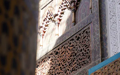 Ornate plaster carvings on a Marrakesh building facade, featured in a 2-hour workshop tour.