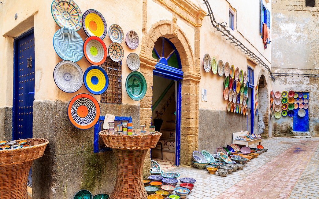 Colorful ceramic plates displayed on a wall in Essaouira, Morocco.
