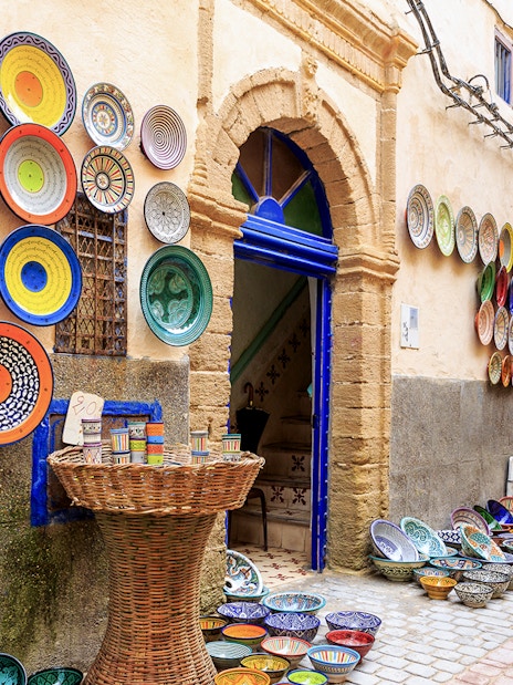 Colorful ceramic plates displayed on a wall in Essaouira, Morocco.