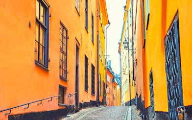 Narrow cobblestone street with colorful buildings in Gamla Stan, Stockholm.