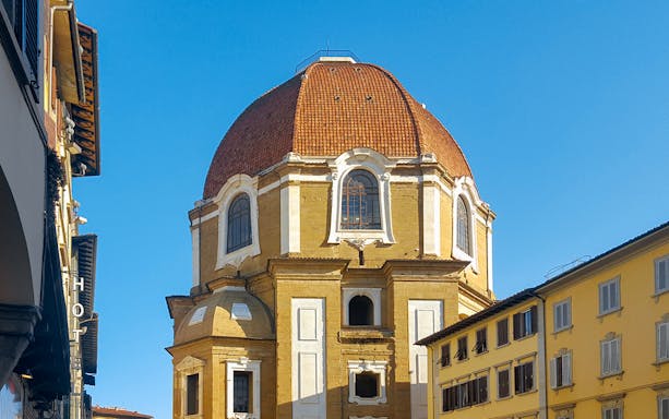 Cappelle Medicee dome and exterior in Florence, Italy, with surrounding buildings.