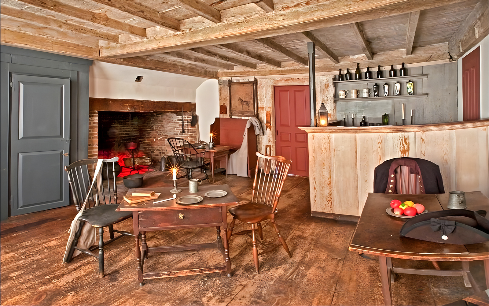 Interior of Buckman Tavern in Boston with colonial-era furnishings and fireplace.