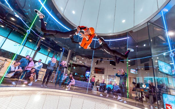 Indoor skydiving experience at iFly Sydney with instructors guiding a participant.