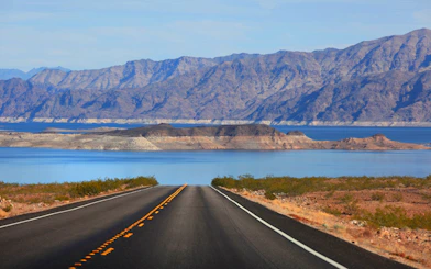 Desert road leading to Lake Mead with mountains in the background near Las Vegas.