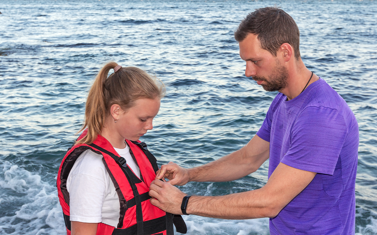 Crew member demonstrating safety instructions on a Sydney Harbour cruise with life jacket