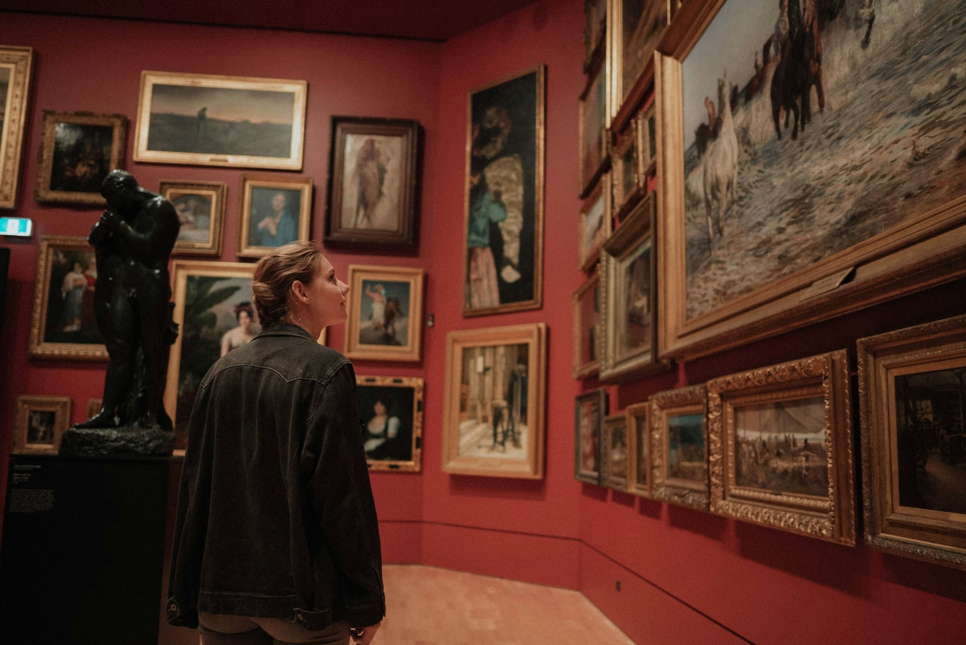 Visitors observing Renaissance art in Uffizi Museum, Florence.