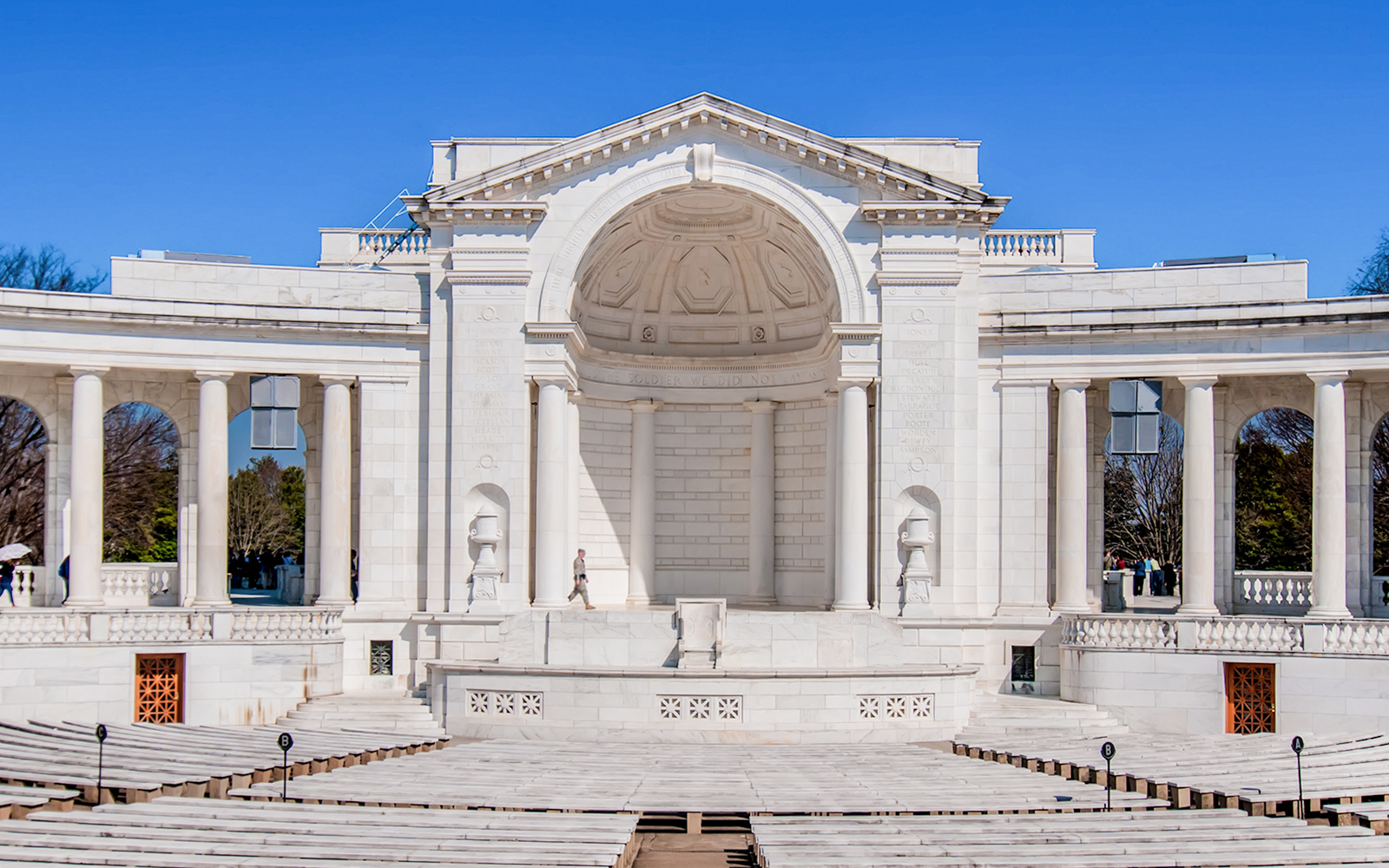 Memorial Amphitheater at Arlington Cemetery with white columns and empty seating.