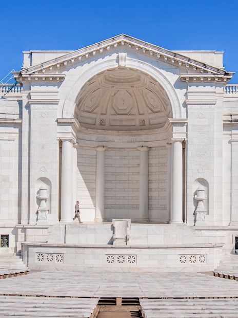 Memorial Amphitheater at Arlington Cemetery with white columns and empty seating.