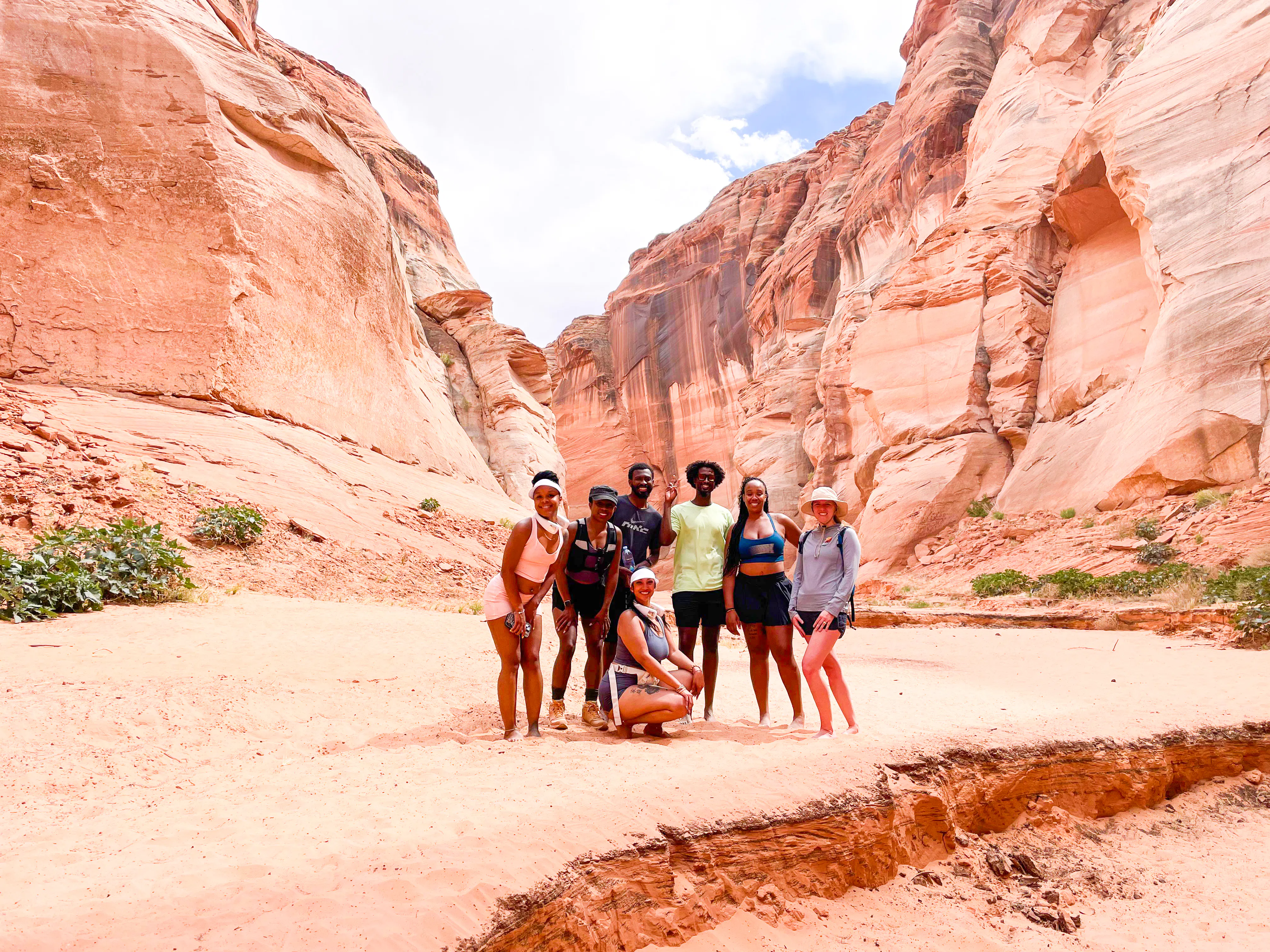 Group of hikers in Antelope Canyon, Page, surrounded by red rock formations.