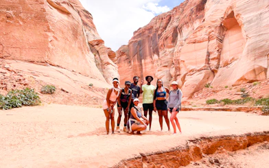 Group of hikers in Antelope Canyon, Page, surrounded by red rock formations.
