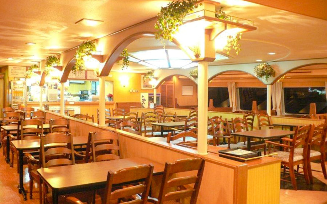 Wood-paneled seating area inside the Santa Maria cruise ship, Osaka Bay.