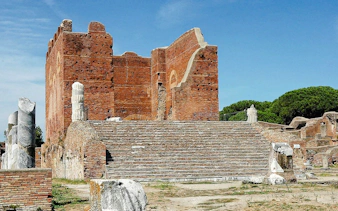 Ostia Antica ruins with ancient brick structure and marble columns, Rome.