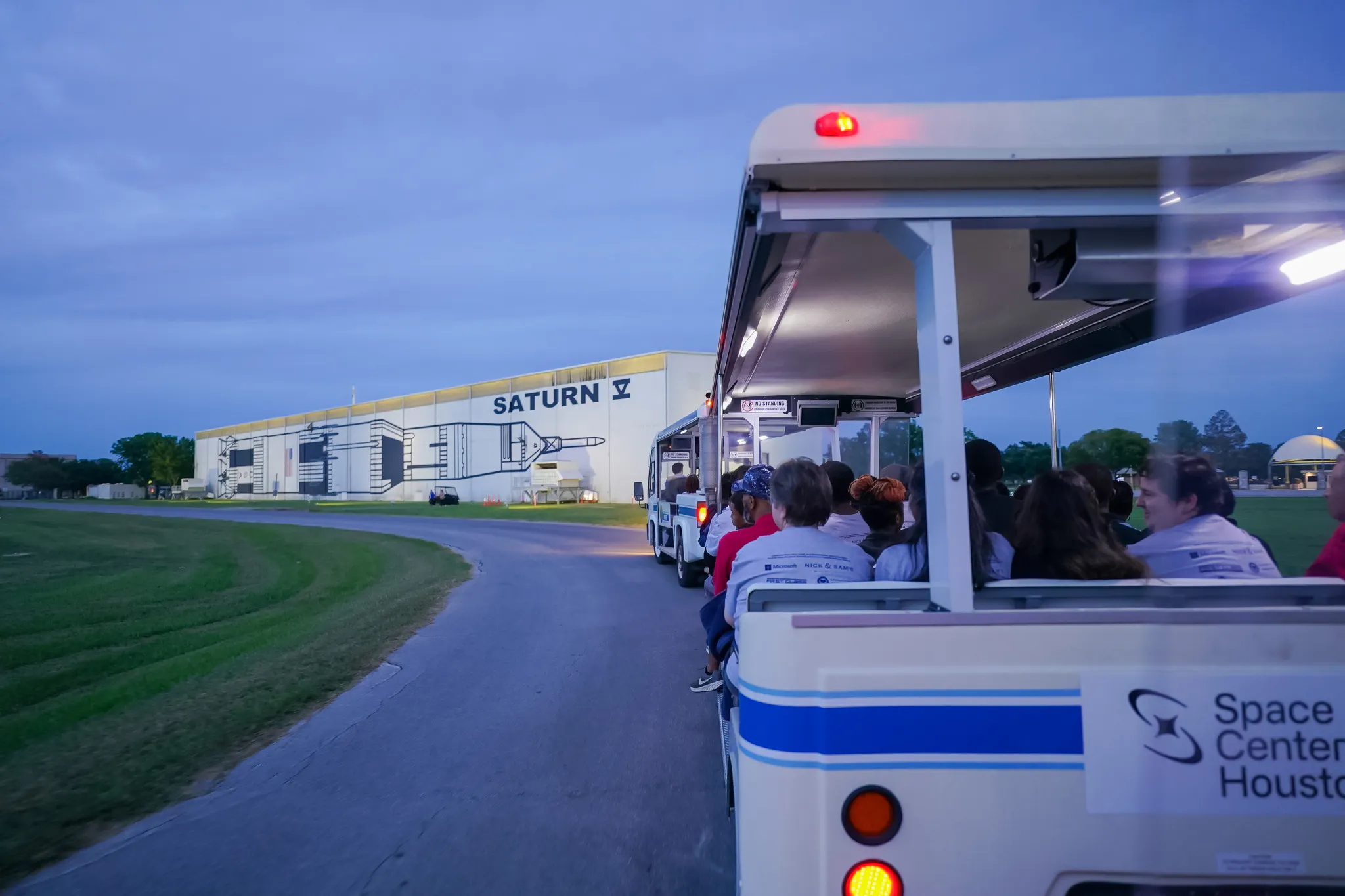Tram tour approaching Saturn V building at Space Center Houston.
