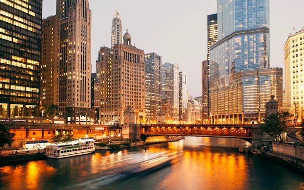 DuSable Bridge illuminated at twilight with Chicago skyline in the background.