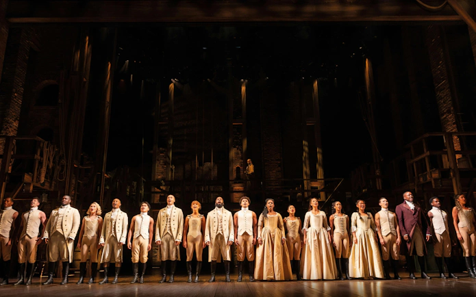 Cast of Hamilton performing on West End stage, London.