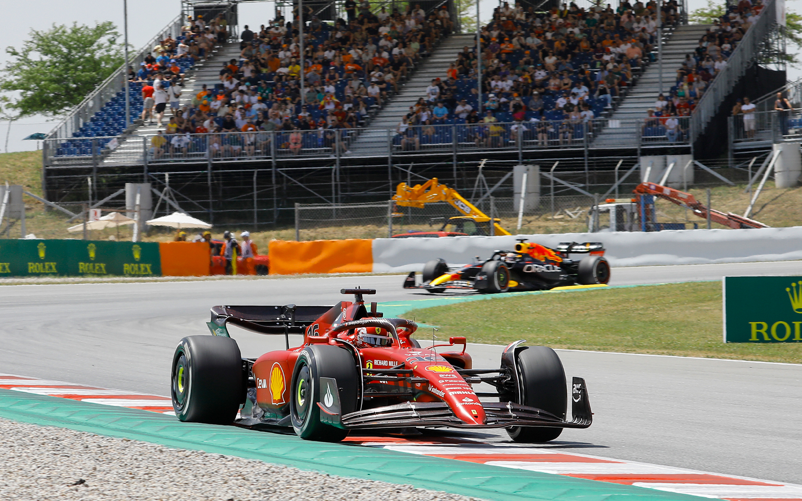 Formula 1 cars racing on the track at Barcelona's Circuit de Catalunya.