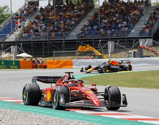 Formula 1 cars racing on the track at Barcelona's Circuit de Catalunya.