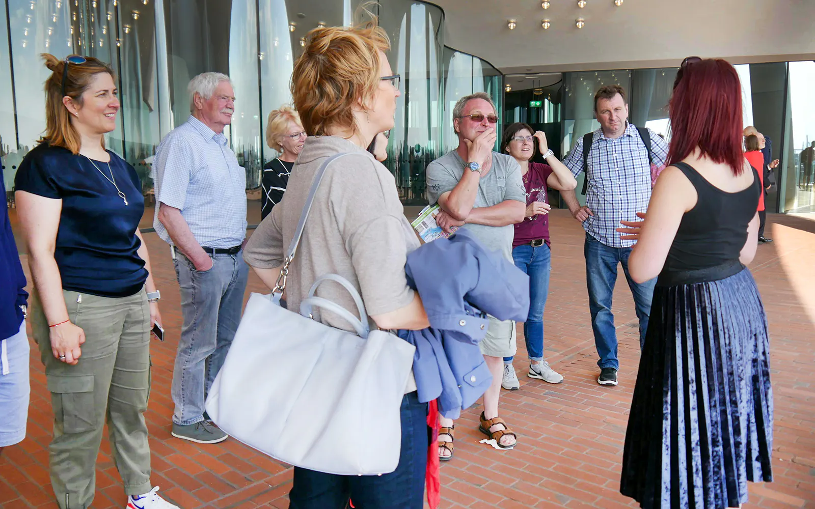 Tour group listening to a guide at Elbphilharmonie Plaza, Hamburg.