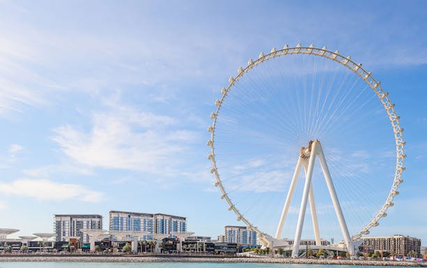 Ferris wheel on Bluewaters Island, Dubai, with cityscape in the background.