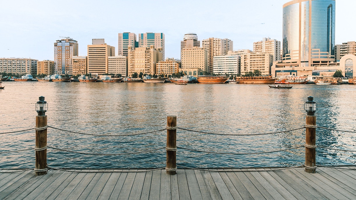 Dubai Creek waterfront with view of Deira Tower and surrounding skyline.