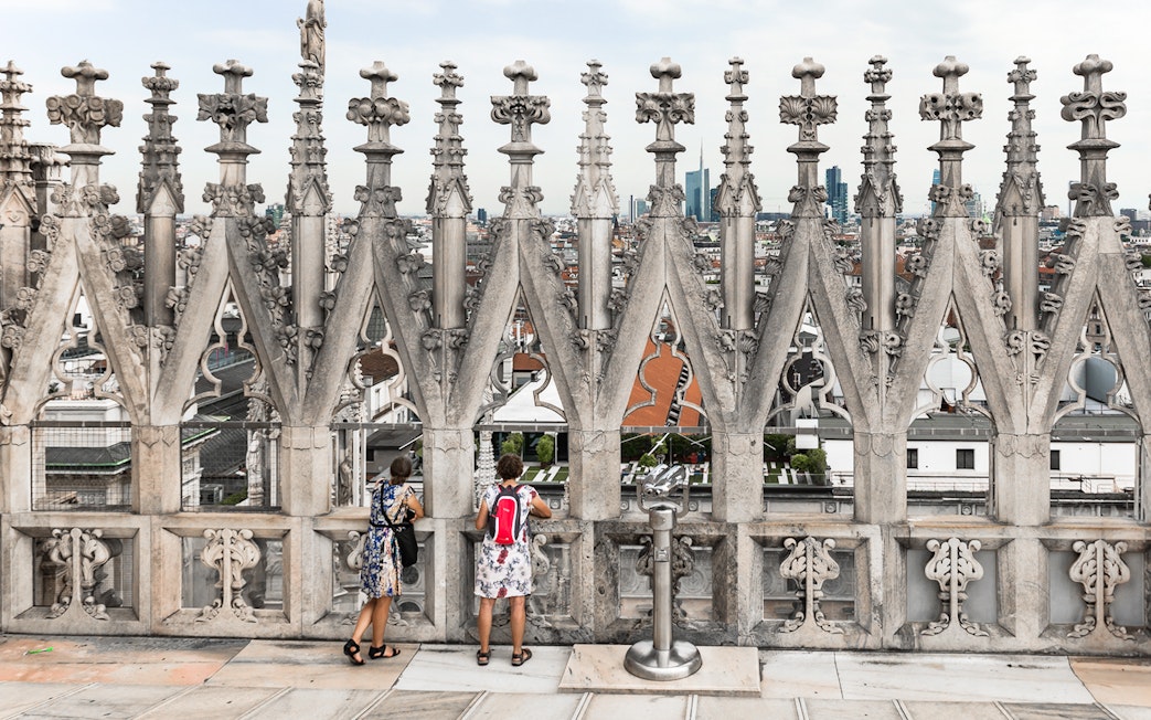 Visitors enjoying the view from the rooftop of Milan Duomo Cathedral.