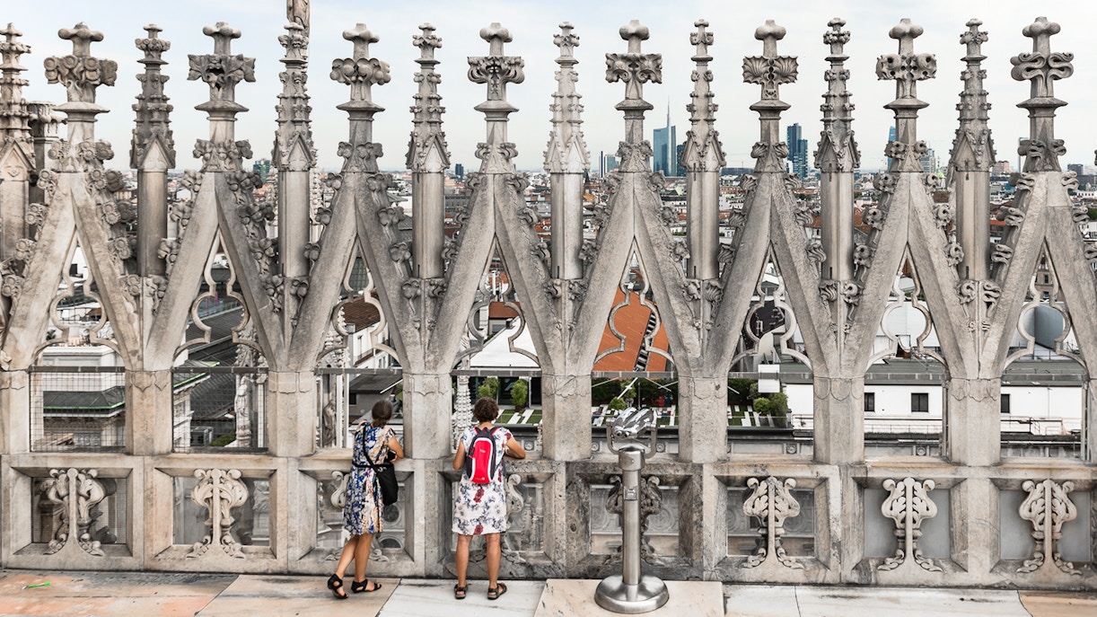 Visitors enjoying the view from the rooftop of Milan Duomo Cathedral.