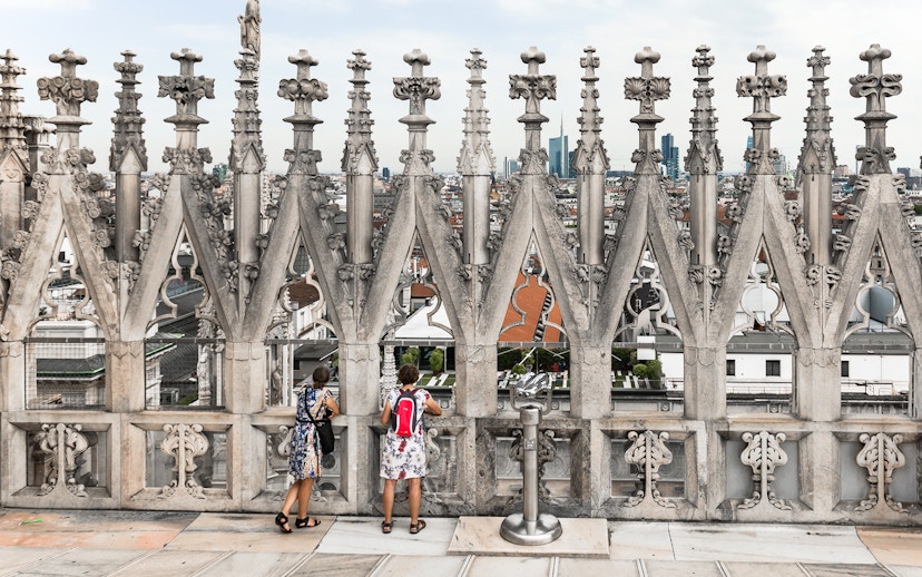 Visitors enjoying the view from the rooftop of Milan Duomo Cathedral.