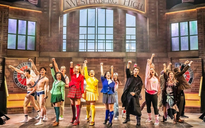 Cast of Heathers the Musical performing on West End stage at Westerberg High.