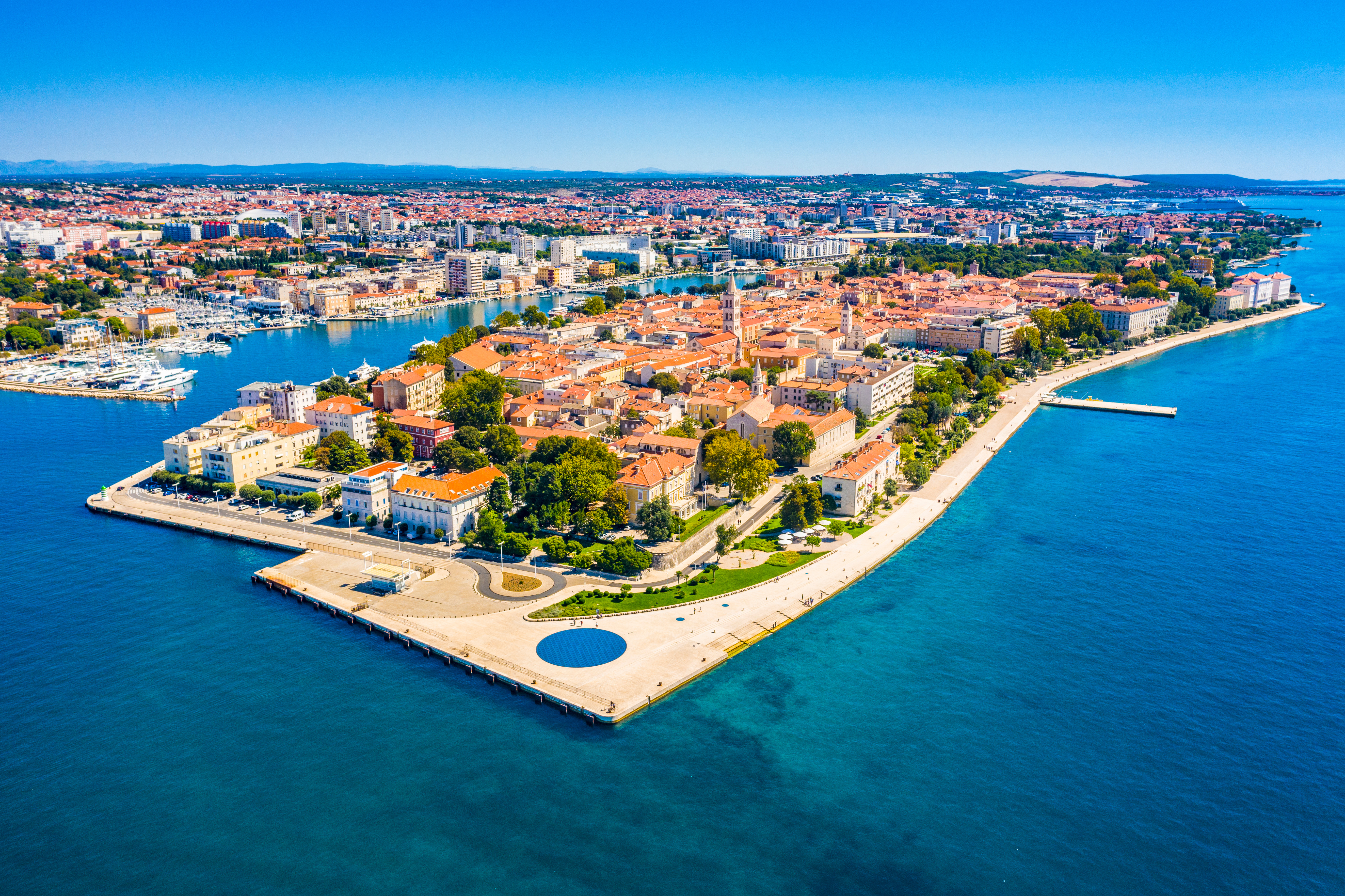 Aerial view of Zadar's Old Town peninsula, Croatia, surrounded by blue Adriatic Sea.