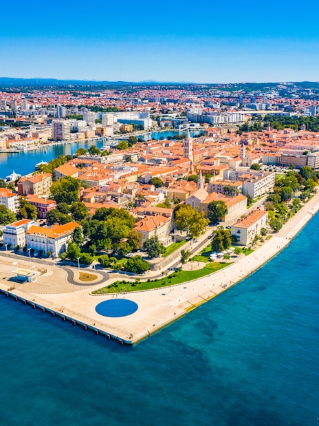 Aerial view of Zadar's Old Town peninsula, Croatia, surrounded by blue Adriatic Sea.
