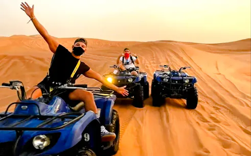 Quad biking adventure in Dubai Lahbab Desert with riders on sand dunes.