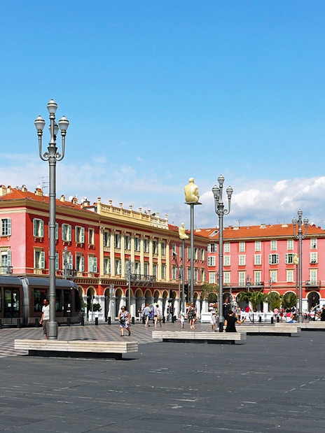 Place Masséna in Nice with colorful buildings and tram, part of self-guided audio tour.