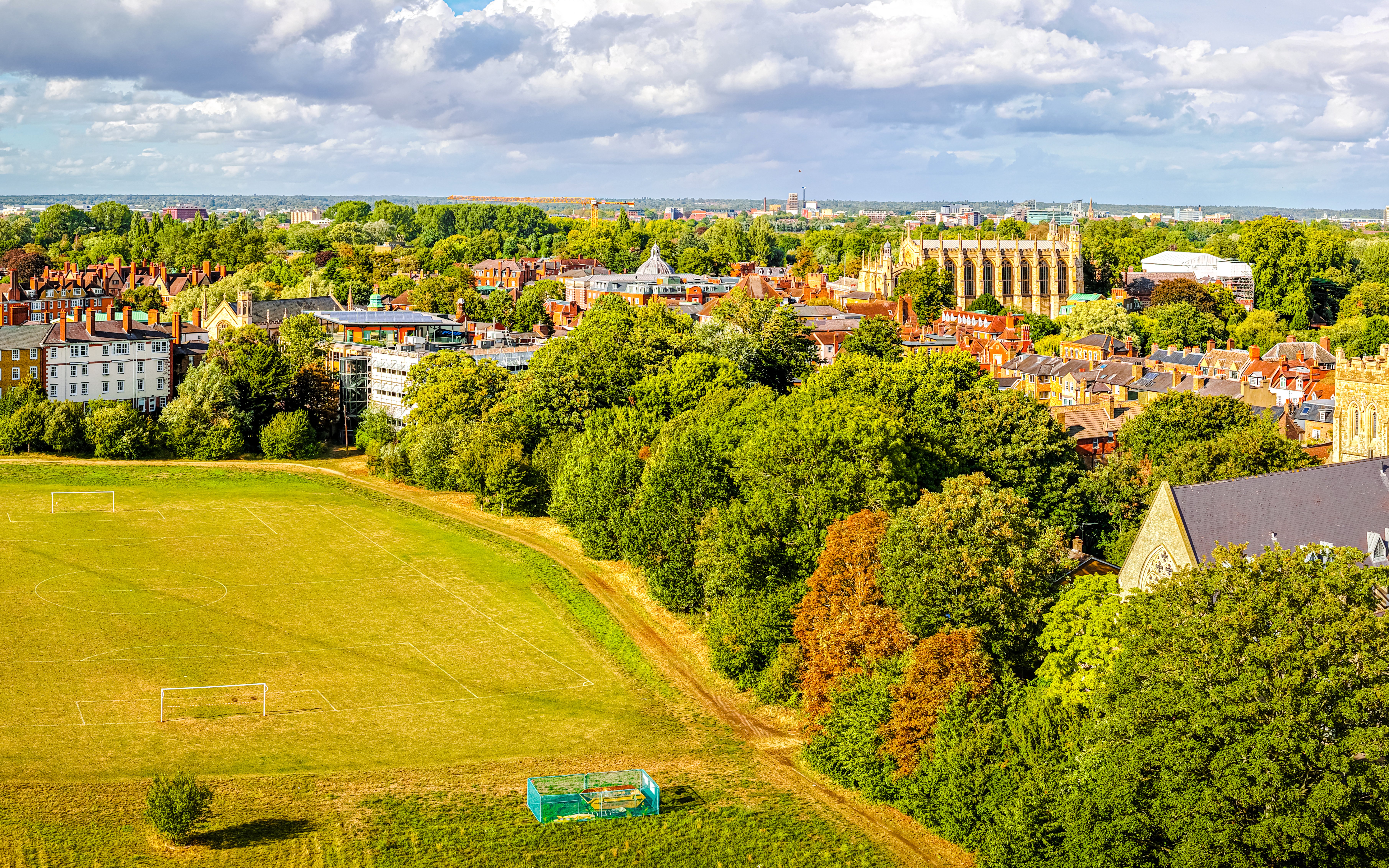 Aerial view of Eton College and historic town buildings surrounded by lush greenery.