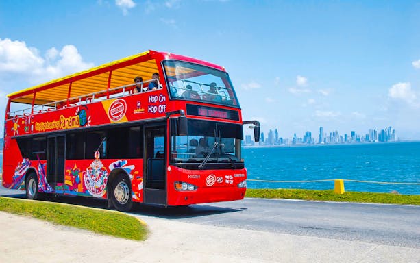 Hop On Hop Off tour bus in Panama City with skyline view.