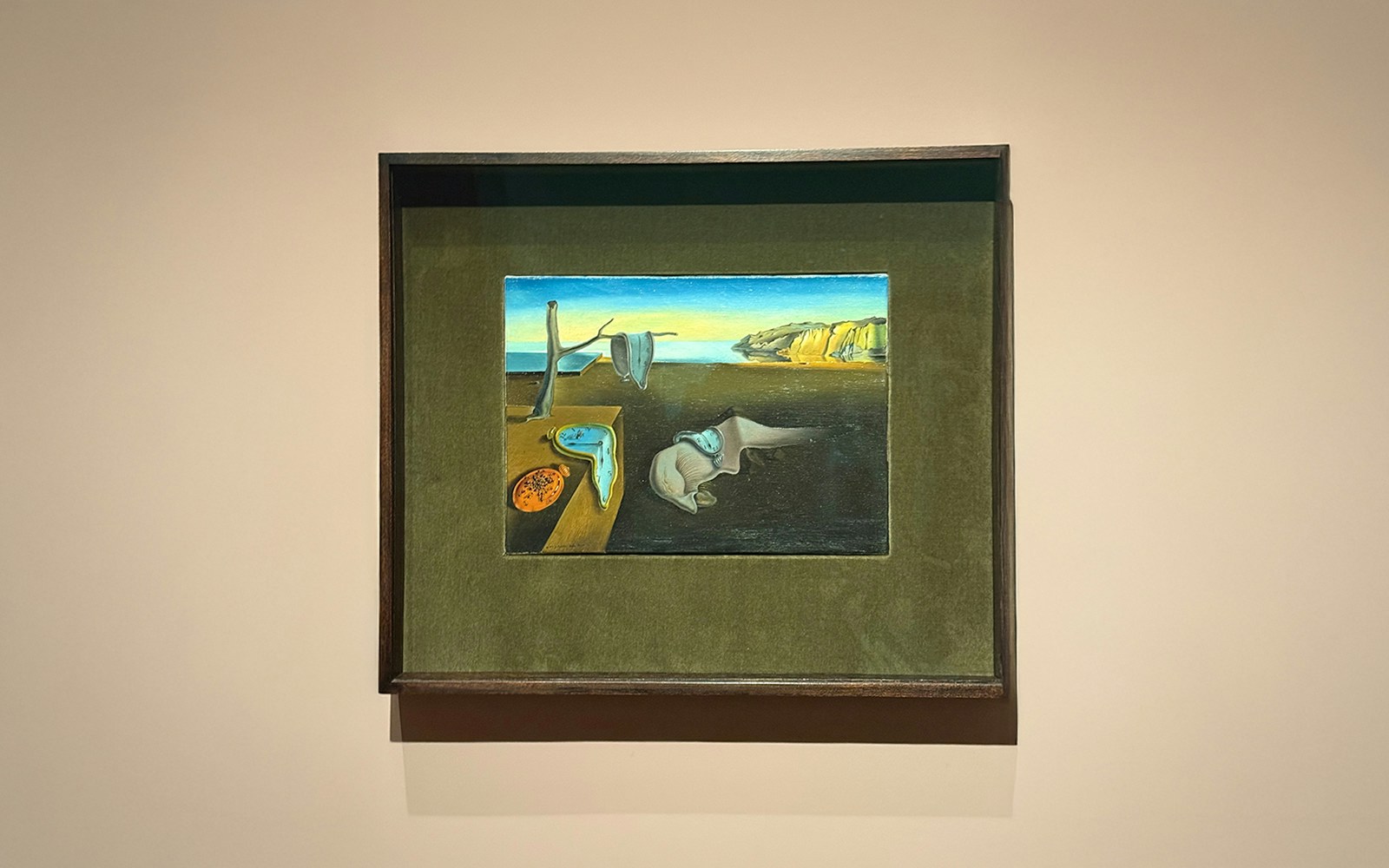 Salvador Dalí's "The Persistence of Memory" at MOMA, featuring melting clocks in a surreal landscape.