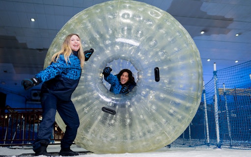 People enjoying a giant ball ride at Ski Dubai Snow Park.