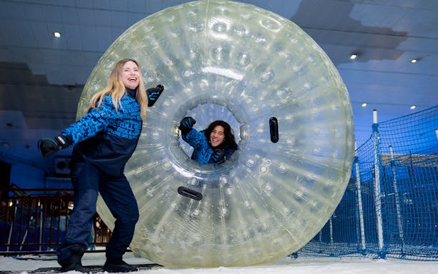 People enjoying a giant ball ride at Ski Dubai Snow Park.