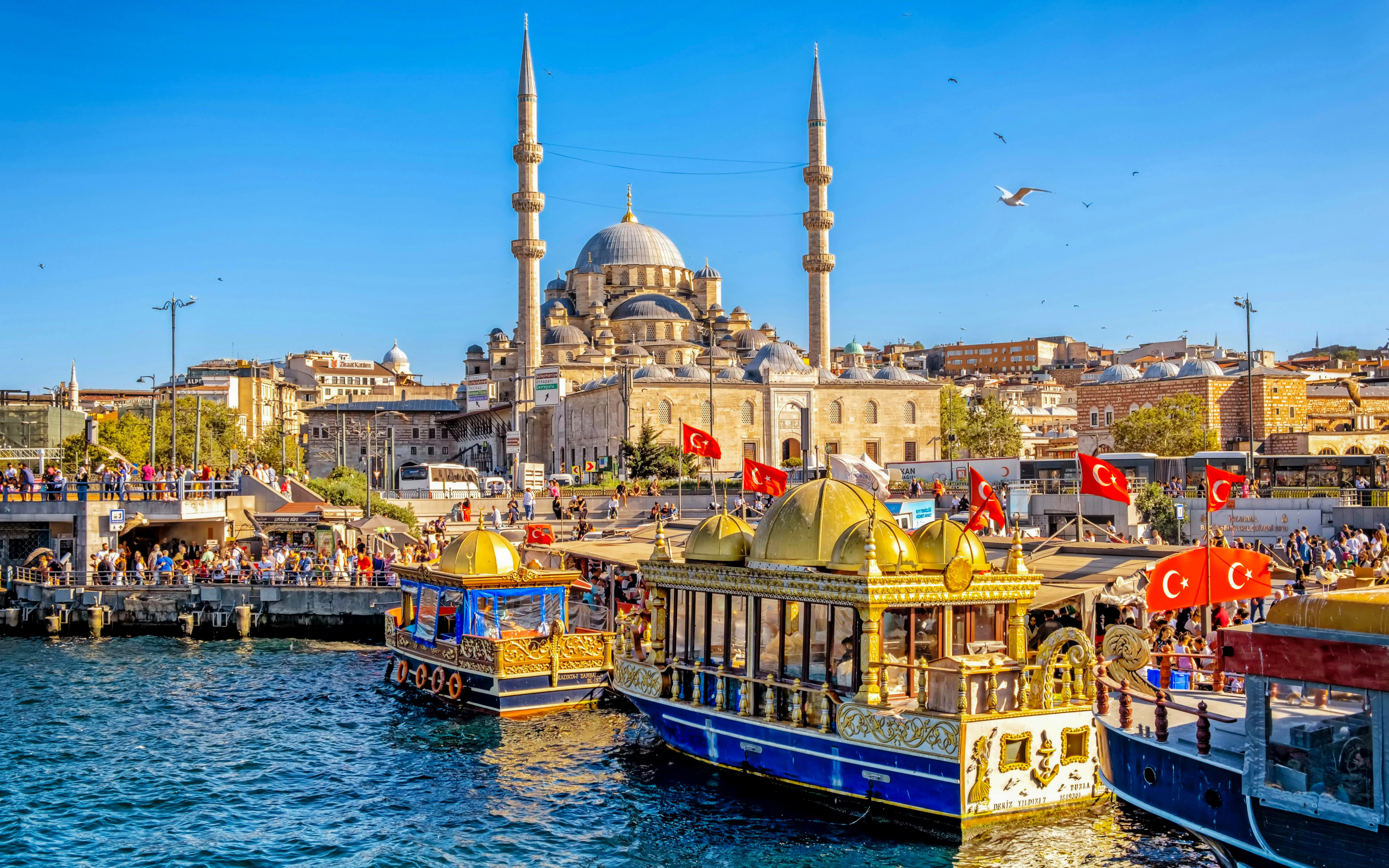 New Sultan Mosque in Eminonu, Istanbul with boats on the Bosphorus, part of Taste of Two Continents Food Tour.